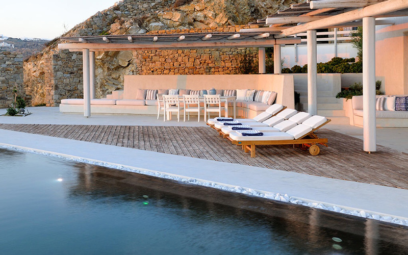 pool area with sunbeds at sunset