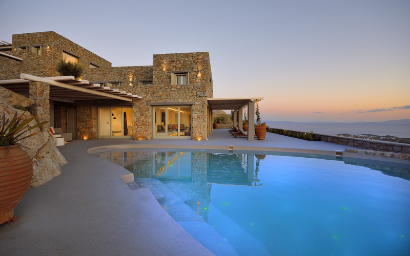 villa with pool area at sunset