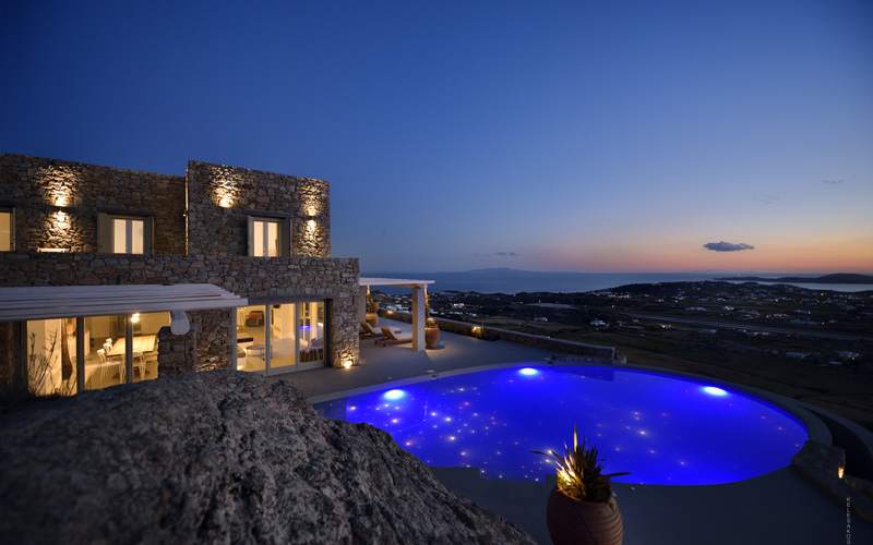 villa with a pool at night