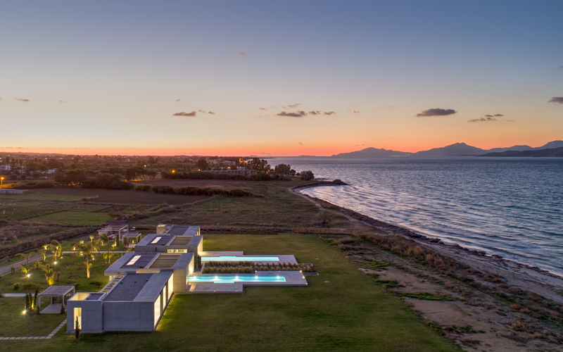 aerial photo of a villa with pool at sunset