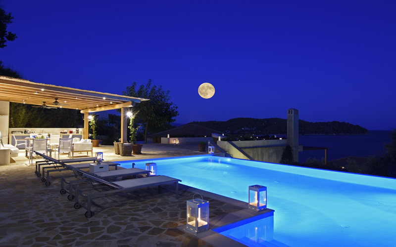 sunbeds by the pool at night