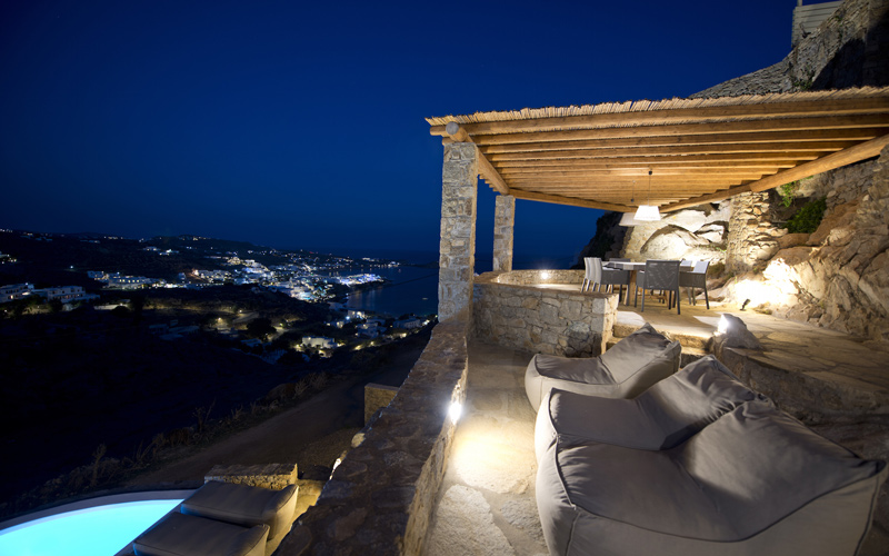 outdoors lounging area by the pool at night