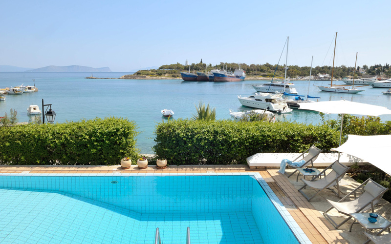 sunbeds by the pool and sea view