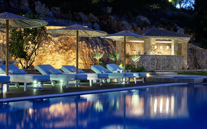 sunbeds by the pool at night