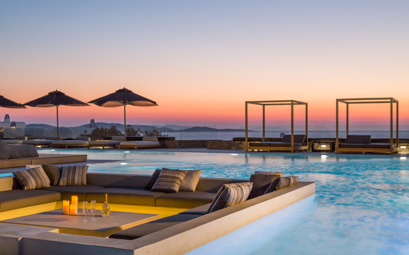 lounge inside pool area at sunset
