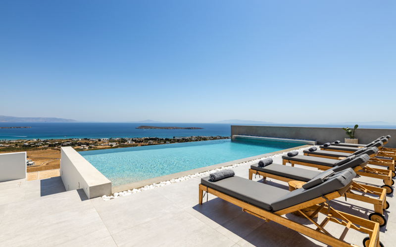 pool with sunbeds and sea view