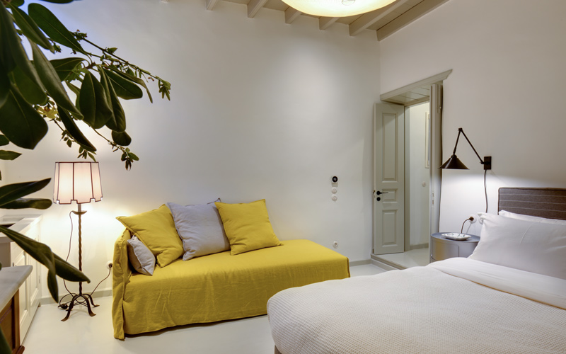 double bedroom with a small sofa