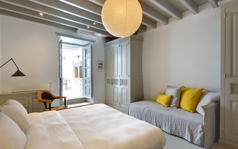 double bedroom with small sofa