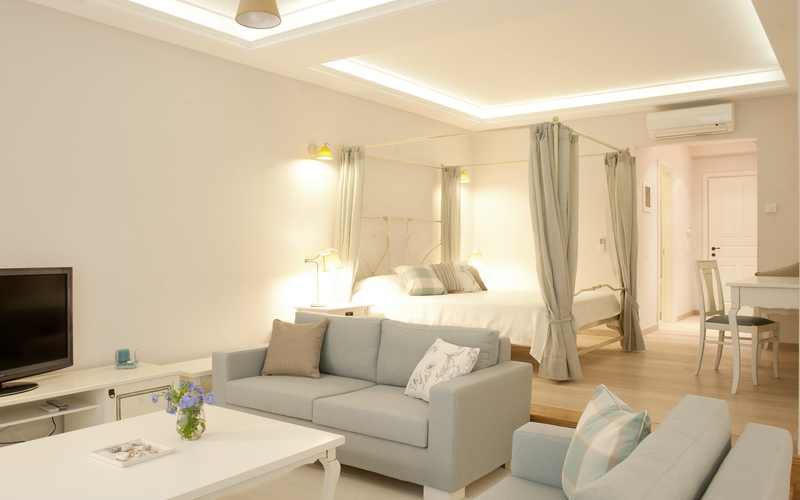 master bedroom with sofas and TV