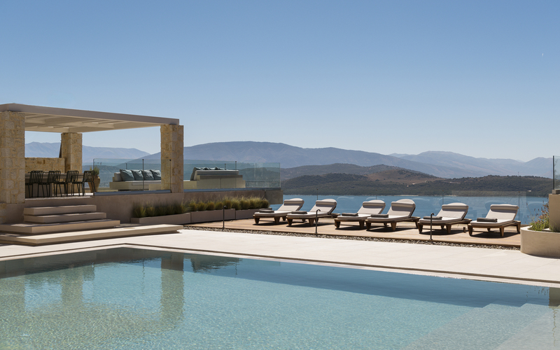 pool area with sunbeds and sea view